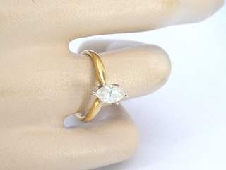 Gouden solitaire ring met een marquise geslepen diamant in witte zetti