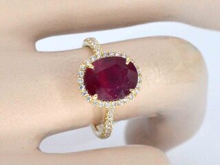 Gouden entourage ring met diamanten en robijn