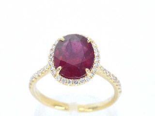 Gouden entourage ring met diamanten en robijn